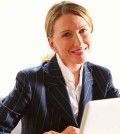 one of smiling women bloggers working on laptop