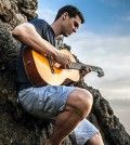 Man having holiday fun playing guitar