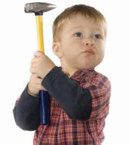 kid showing bad temper with a hammer in hand