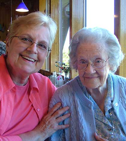 A woman respecting the elderly lady by hugging