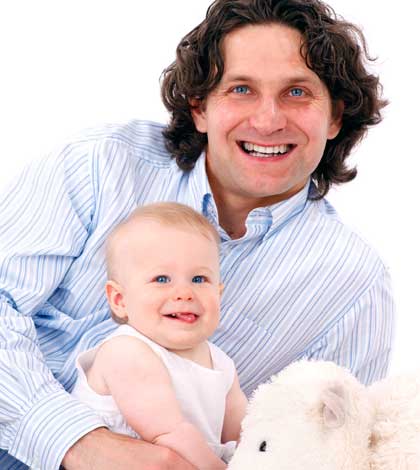 Man playing the role of father in child development with his baby