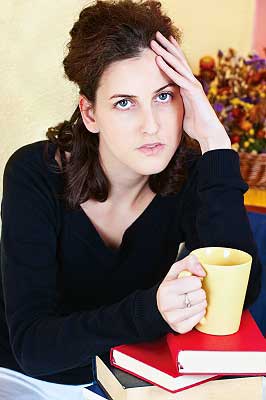 A girl drinking coffee which is one of the ways to reduce stress