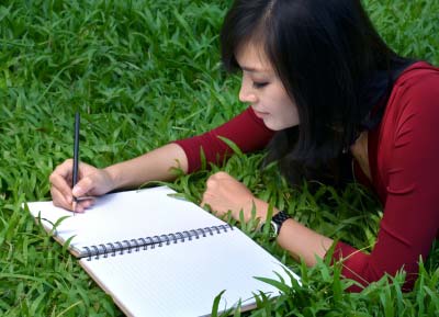 A woman author writing a book