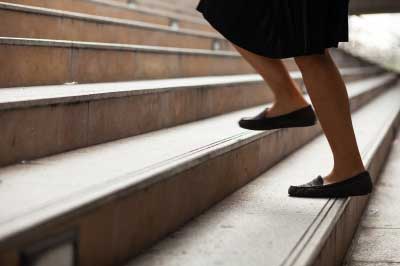 A lady climbing the stairs