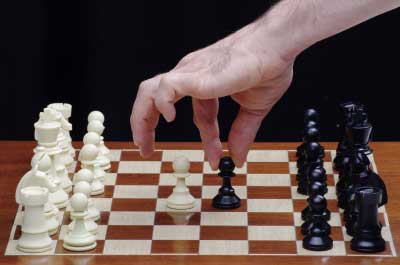 Person playing chess to learn the strategy of success