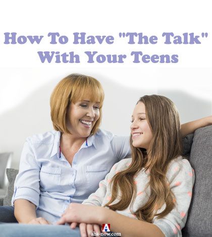 Mother having the talk with her teen daughter sitting on sofa