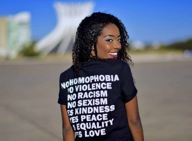 Black woman wearing black custom printed t-shirt with slogans