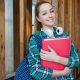 Adolescent girl student in school with books