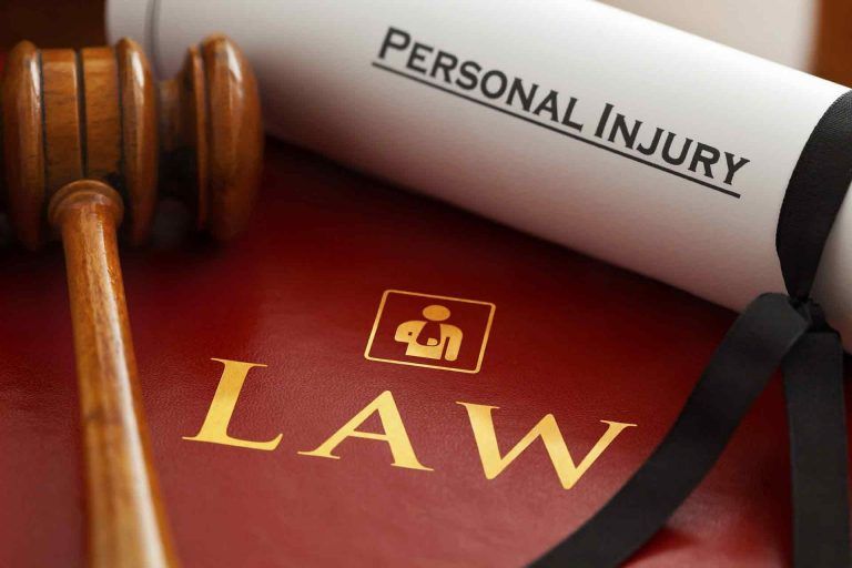 personal injury document upon a law book and hammer