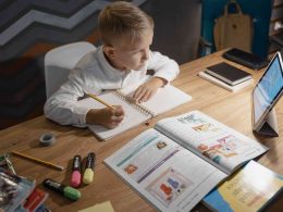 A child distance learning at home on tablet