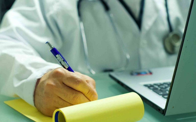 An online doctor writing a medicine prescription