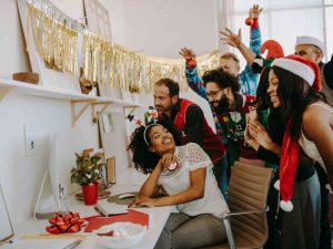 Coworkers celebrating farewell party in office