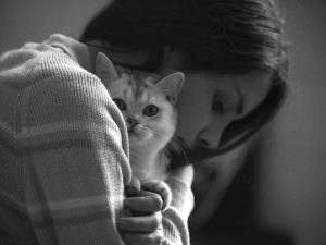 A girl hugging a cat to combat anxiety