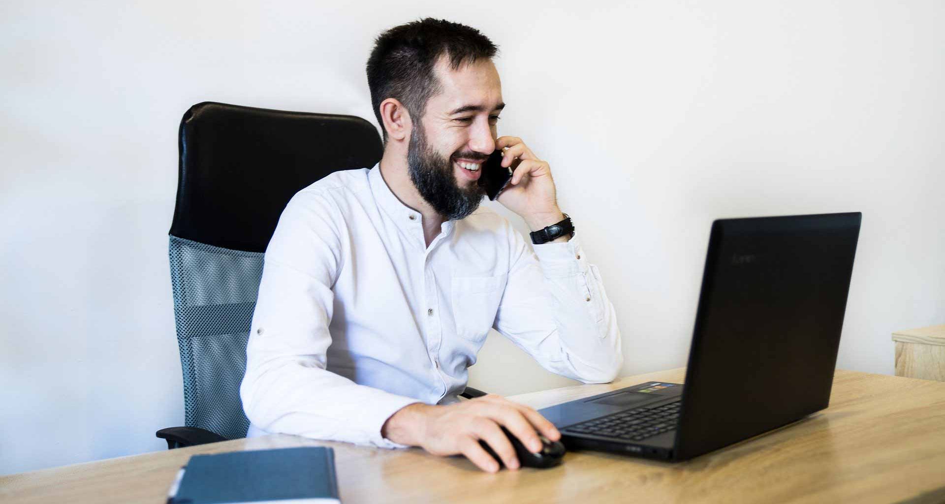 Employer meeting remote working employee on laptop in office