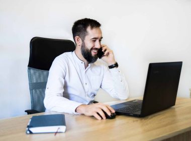 Employer meeting remote working employee on laptop in office