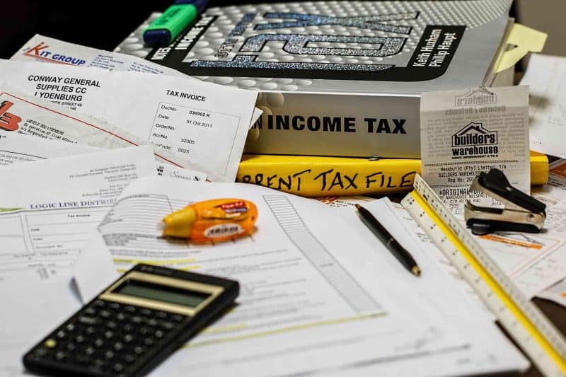 Income tax books, calculator, and taxpapers.