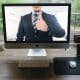 A home office setup at home and a colleague on the monitor screen.