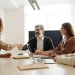 Business heads shaking hands in a successful meeting in the office.