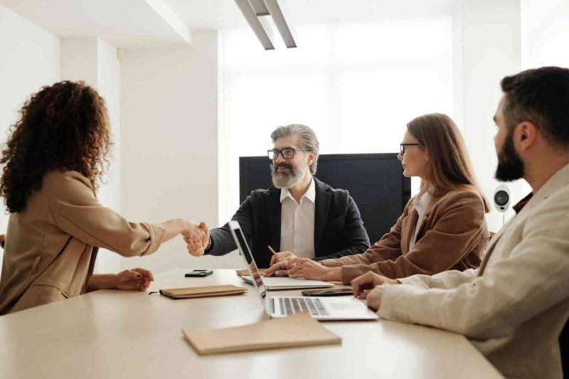 Business heads shaking hands in a successful meeting in the office.
