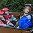 Kids sitting in a cargo bike