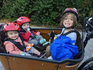 Kids sitting in a cargo bike